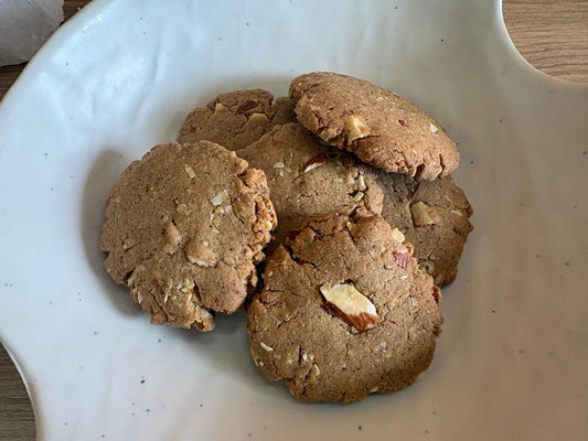 Jowar almond cookies close-up showing almond pieces on a white ceramic bowl, no maida, Fluffiesta Gurgaon