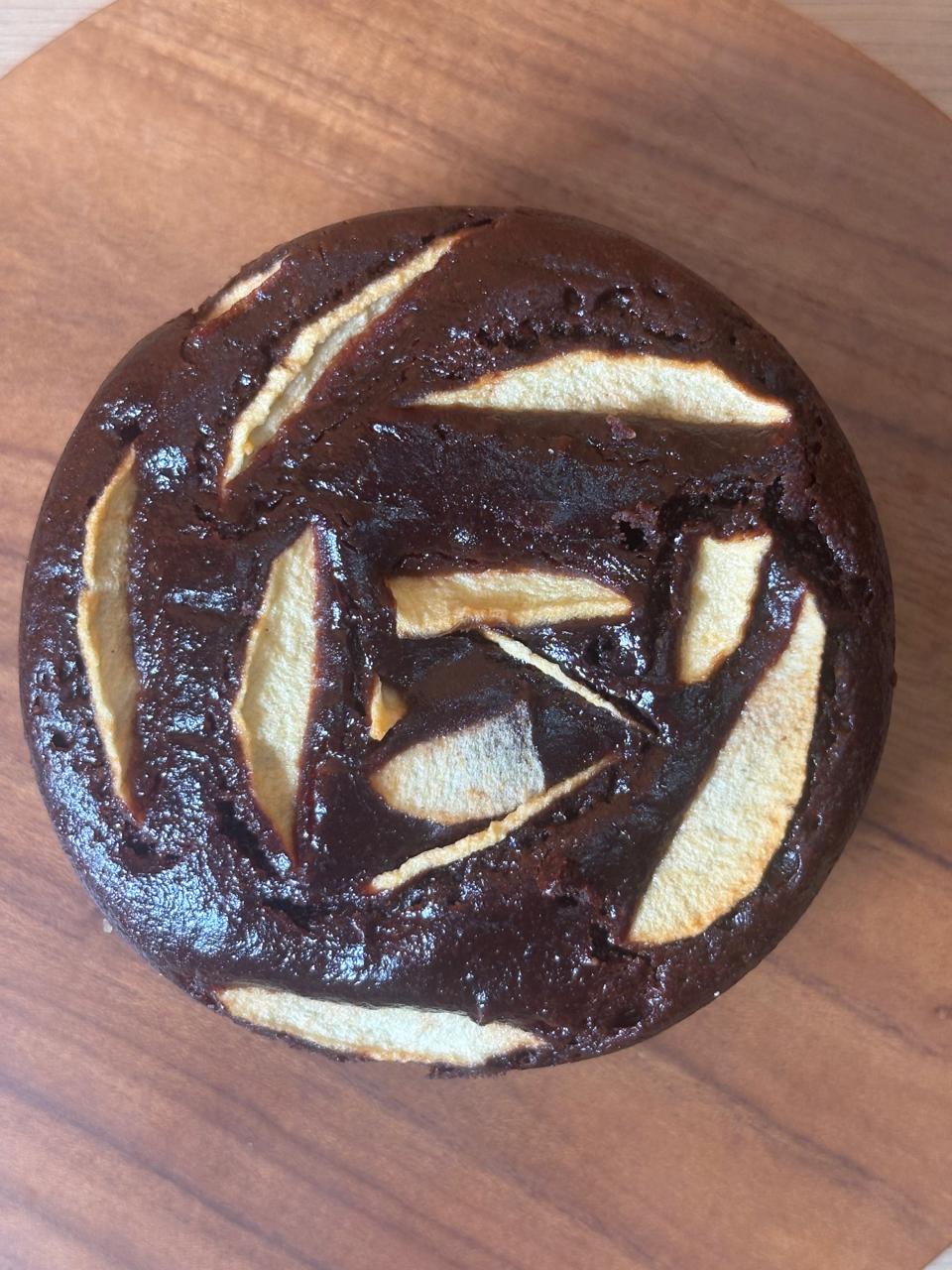 Close-up of dark chocolate apple cake decorated with apple slices