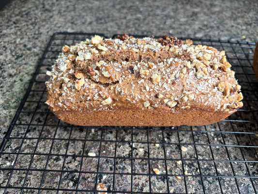 Coffee coconut tea cake loaf on a cooling rack