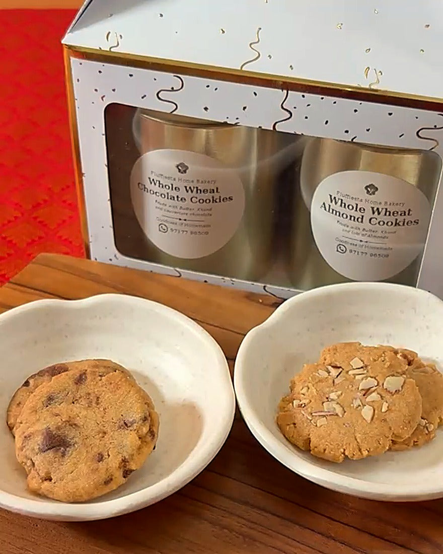 Fluffiesta Diwali Cookie Hamper: white-and-gold gift box with tins of Whole Wheat Chocolate and Almond Cookies, with a cookie of each in white bowls